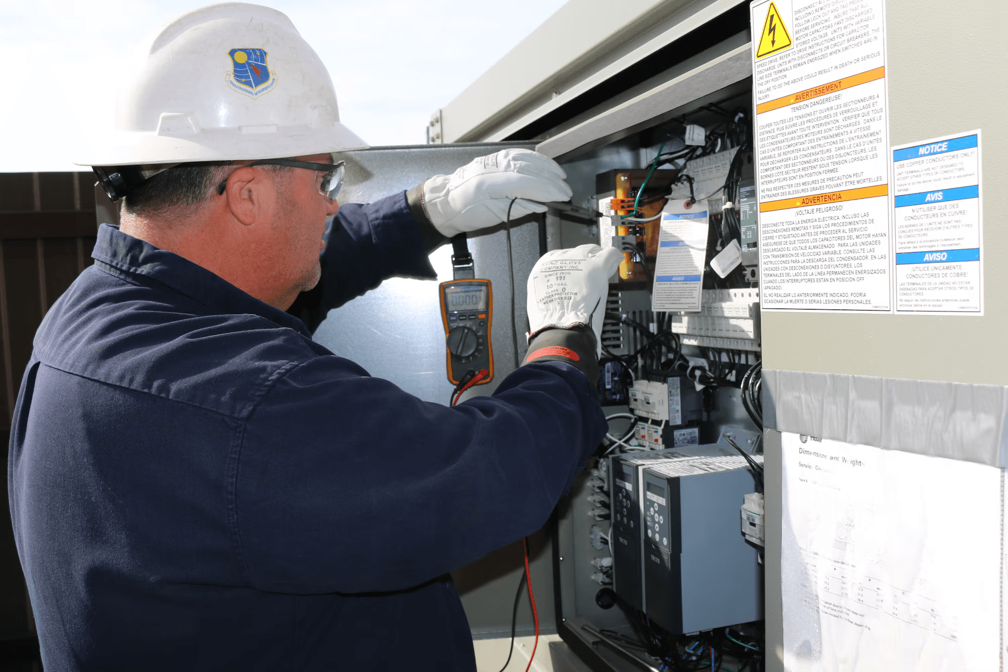 Electrical technician working in a panel
